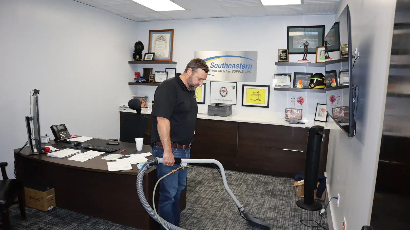SES office with company logo and awards on the wall