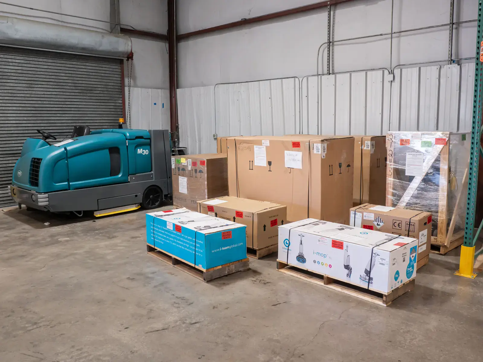 New floor cleaning machines on pallets at the SES shipping dock